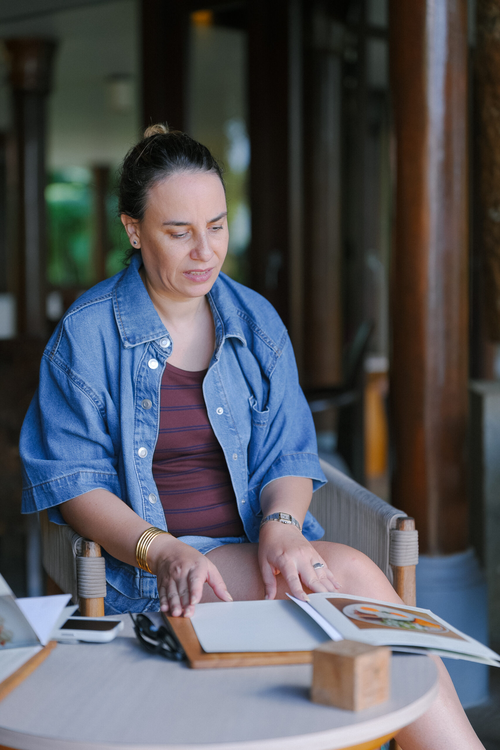 Sophia Benarafa working through planning documents and notes at an outdoor table